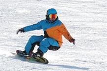 Snowboarder Carving the Slopes